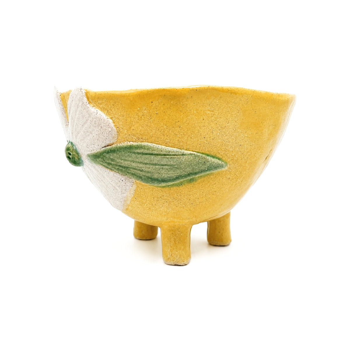 Side view of footed yellow ceramic bowl by Nayla's Ceramics highlighting the green leaf glaze detail