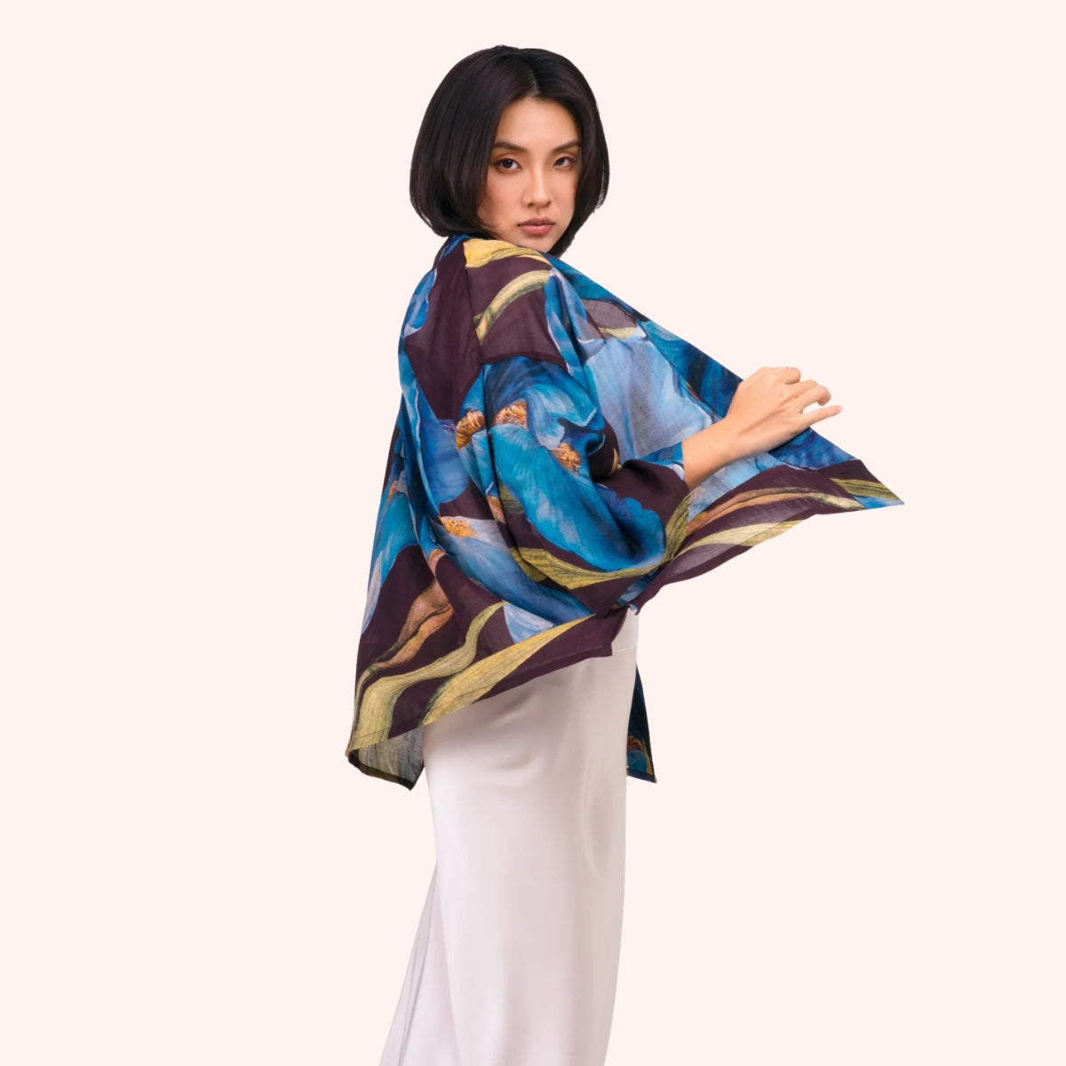Side view of the plum iris print kimono jacket, showing the wide sleeve drape and open front silhouette