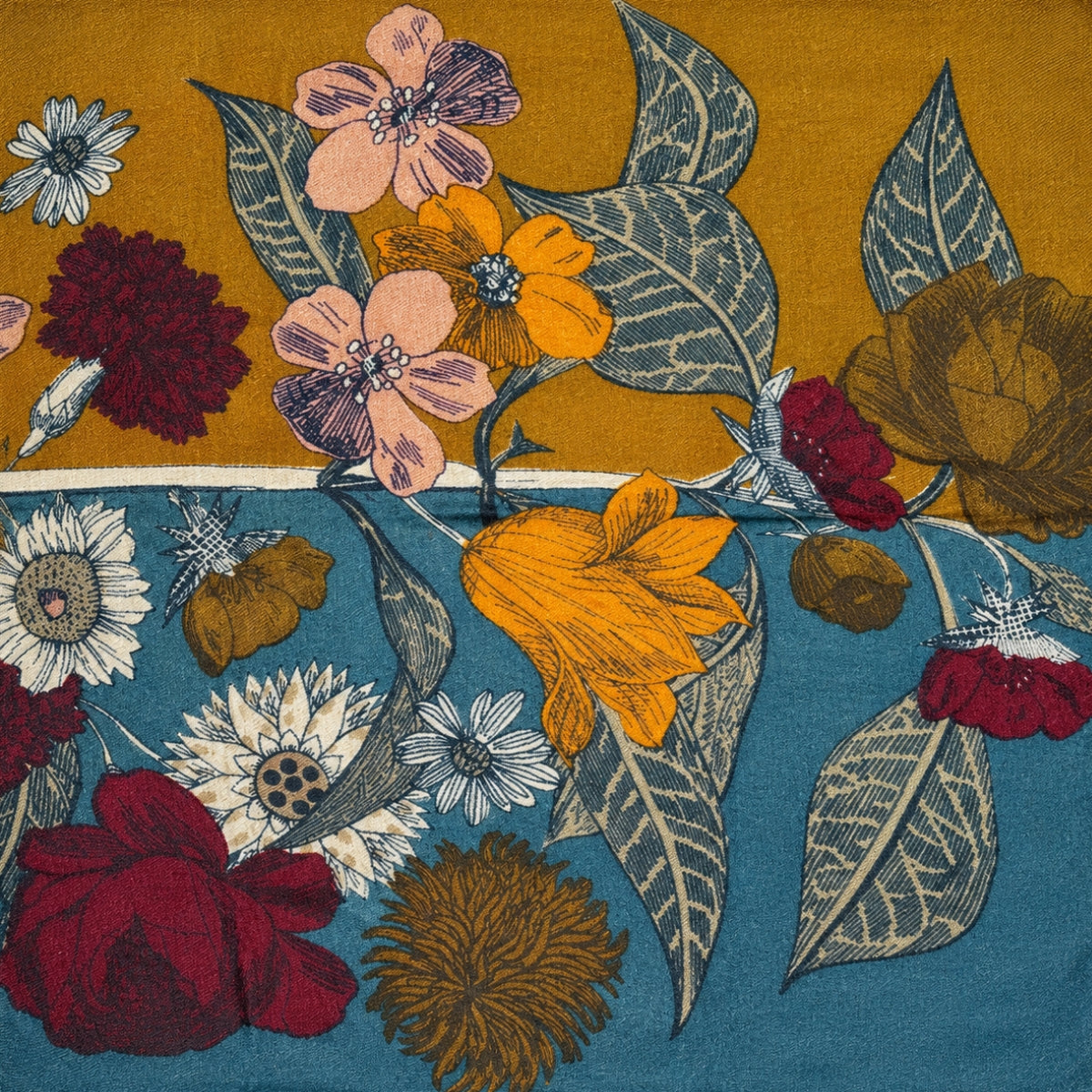 Close-up of the scarf's floral vase motif, showing the antique vase and layered blooms on the olive gold ground