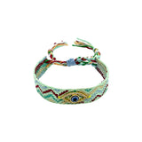 Woven friendship bracelet in mint burgundy and blue zigzag pattern with blue enamel evil eye charm and crystal detail, adjustable pull cord closure