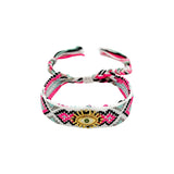 Woven friendship bracelet in pink black and white pattern with gold evil eye charm and crystal detail, adjustable pull cord closure