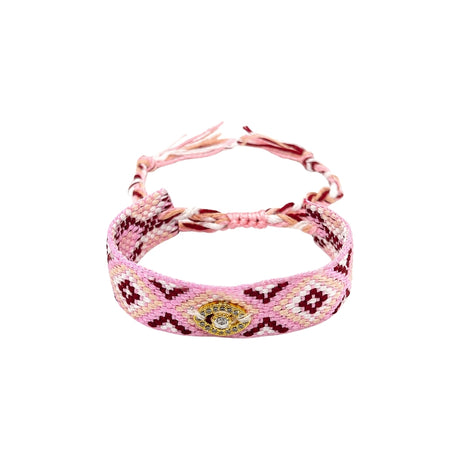 Woven friendship bracelet in pink burgundy and cream diamond shaped pattern with gold evil eye charm and crystal detail, adjustable pull cord closure