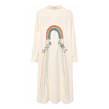 Flat back view of the Boutique Flo Good Vibes Embroidered White Shirt Dress, displaying the full rainbow embroidery and multicolor stitched rays against the ivory fabric