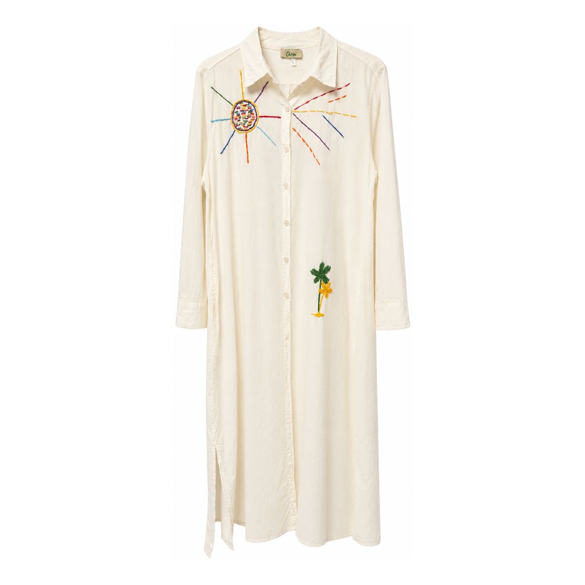 Flat front view of the Boutique Flo Good Vibes Embroidered White Shirt Dress, showing the embroidered sun motif at the chest, palm tree detail, collar, and button-through front