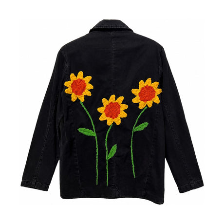 Flat back view of the Boutique Flo Sunflower Bloom Embroidered Black Jacket, displaying the full sunflower embroidery against the washed black denim
