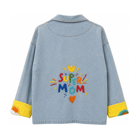 Flat back view of the Boutique Flo Super Mom Embroidered Light Denim Jacket, displaying the full "Super Mom" embroidery and yellow contrast cuffs
