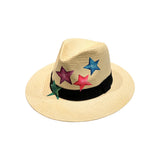 Front view of the City Girl Hand-Painted Colored Stars Wide Rim Hat, showcasing the natural woven straw crown with hand-painted stars in blue, magenta, pink, and green above a black grosgrain band