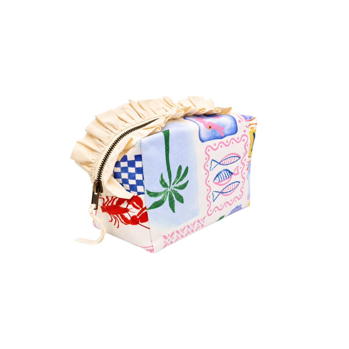 Angle view of the Riviera toiletry bag highlighting the palm tree, fish pattern, and structured boxy shape.