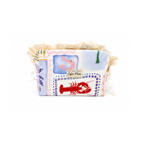 Front view of the Cofin Paris Medium Paola Riviera toiletry bag featuring a cotton Riviera print with lobster, shrimp, and cream ruffled trim.
