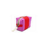 Three-quarter angle view of the Cofin Paris Paola Striped pouch showcasing its bold red and pink striped canvas.