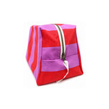 Angle view of the extra large Paola striped toiletry pouch showcasing the vibrant red and pink cotton pattern.
