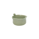Front view of Nayla's Ceramics light green wavy round ceramic snack bowl featuring a sculpted ceramic bird on the rim