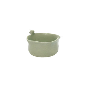 Front view of Nayla's Ceramics light green wavy round ceramic snack bowl featuring a sculpted ceramic bird on the rim