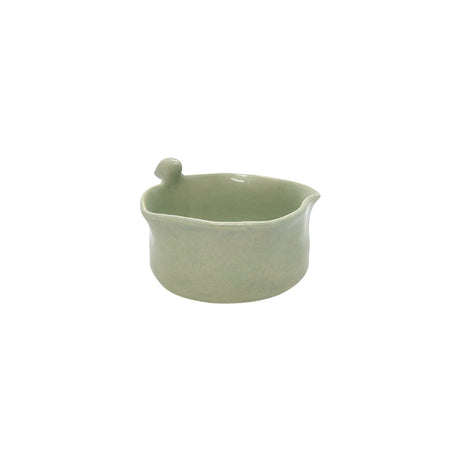 Front view of Nayla's Ceramics light green wavy round ceramic snack bowl featuring a sculpted ceramic bird on the rim