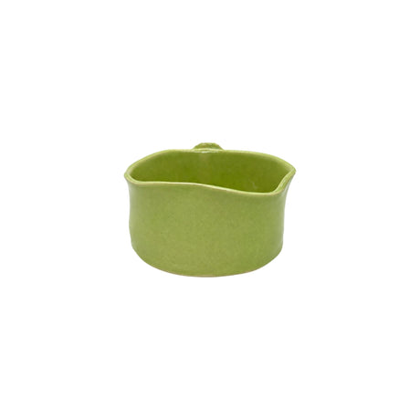 Back view of Nayla's Ceramics lime green wavy round ceramic bowl showing the handcrafted glaze finish