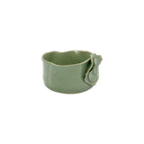 Three-quarter angle of Nayla's Ceramics old green wavy bowl highlighting the interior opening and sculpted floral motif