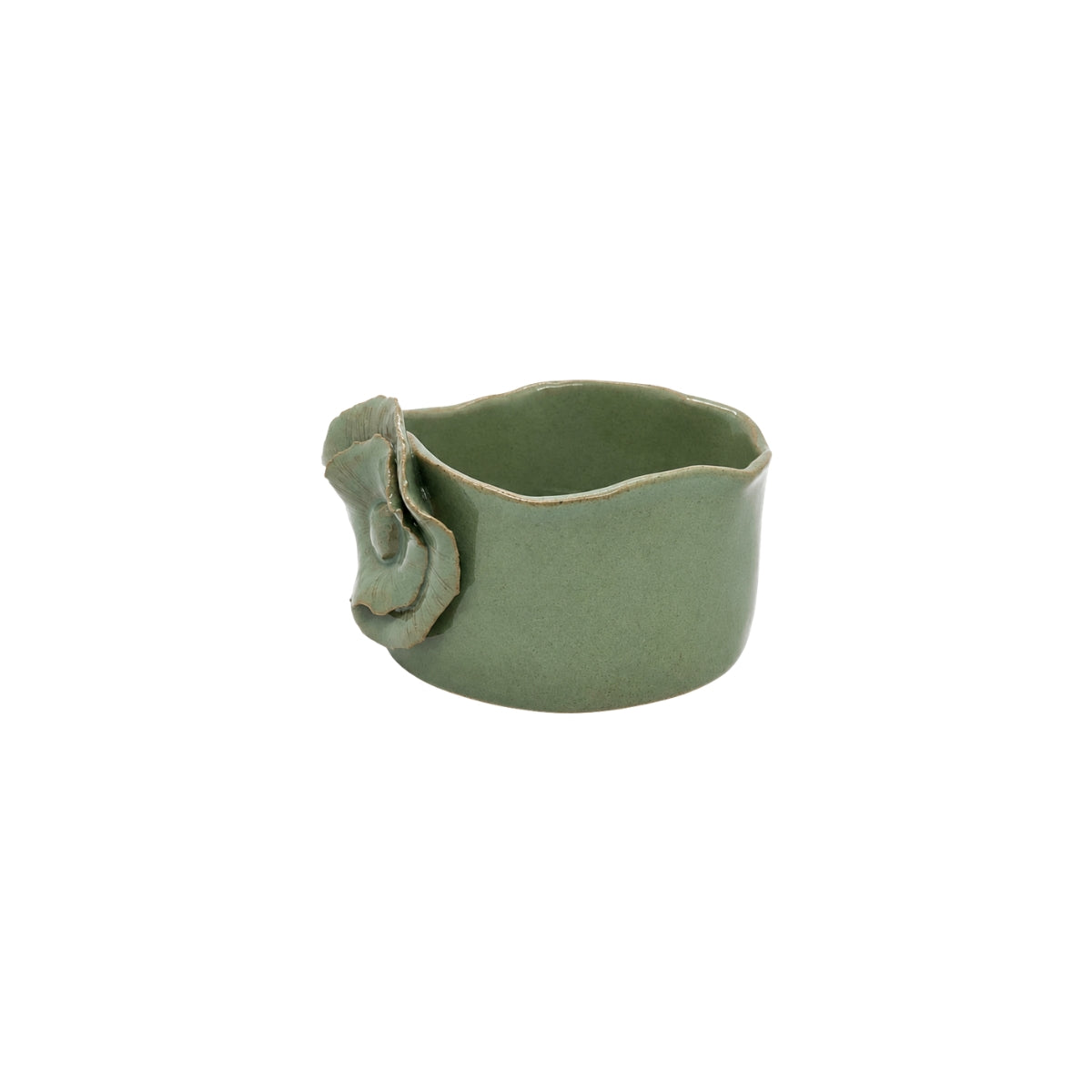 Side view of sage green pottery dish by Nayla's Ceramics displaying wavy rim contour and raised flower side placement