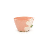 Angled view of Nayla's Ceramics hand-sculpted pink flower ceramic bowl showing 3D clover blossom detail and interior rim