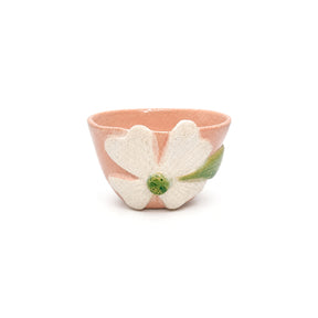 Front view of handcrafted pink clover ceramic bowl by Nayla's Ceramics featuring a raised off-white flower with a green center