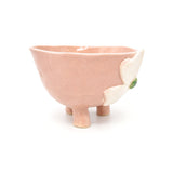 Angled view of Nayla's Ceramics footed pink flower ceramic bowl showing tripod legs and 3D clover blossom detail