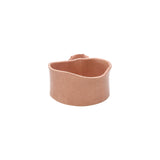 Back view of soft pink wavy round ceramic bowl by Nayla's Ceramics highlighting hand-molded form