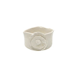Front view of Nayla's Ceramics white wavy round ceramic bowl showing the sculpted floral accent