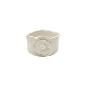 Front view of Nayla's Ceramics white wavy round ceramic bowl showing the sculpted floral accent
