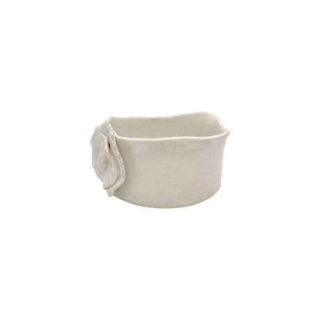Side view of cream-colored handmade ceramic dish by Nayla's Ceramics showing the wavy rim line