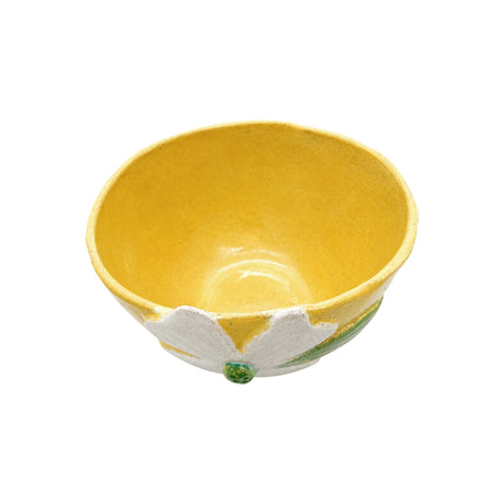 Top view looking inside the yellow handcrafted ceramic footed bowl by Nayla's Ceramics showing interior glaze and floral rim detail
