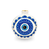 Front view of a white ceramic pomegranate shape featuring a hand-painted blue mandala evil eye pattern with gold accents and a gold rimmed opening.