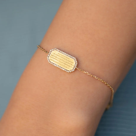 Model wearing the Orchid Jewelry 18k gold and diamond Ayatul Kursi calligraphy bracelet styled on wrist