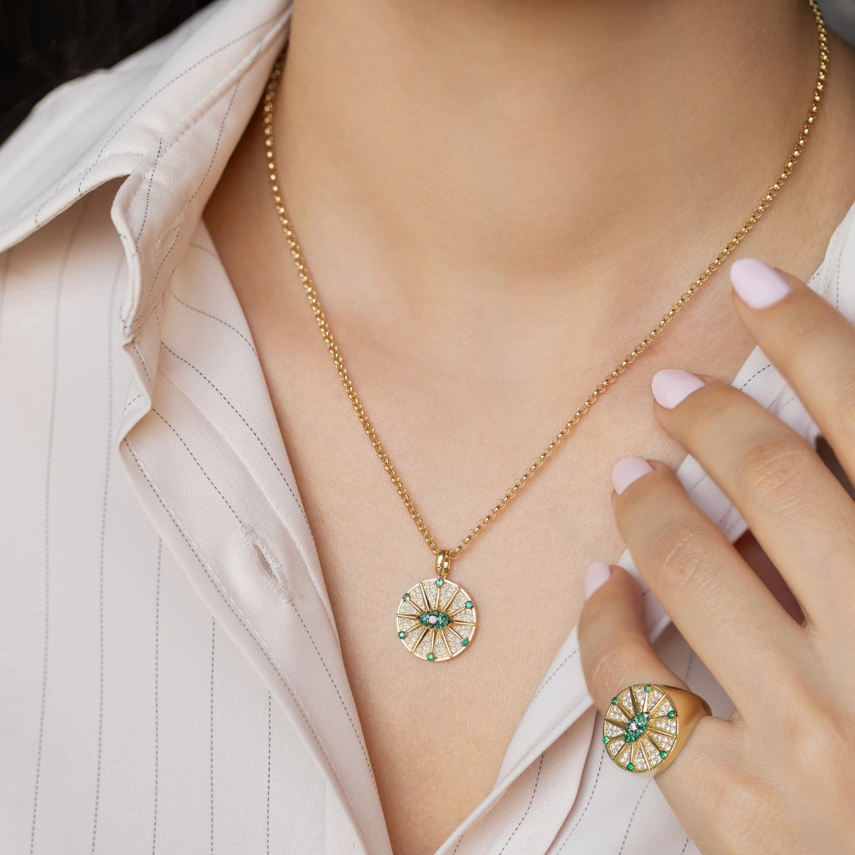 Model wearing Orchid Jewelry 18k gold emerald and diamond O'hara pendant necklace along the neckline
