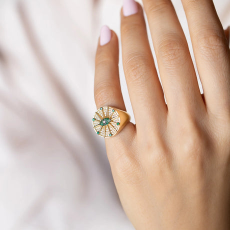 Model wearing Orchid Jewelry 18k yellow gold emerald and diamond O'hara signet ring on finger