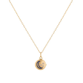 Orchid Jewelry 18k yellow gold circular locket necklace featuring a sapphire crescent moon and diamond stars on a paperclip chain