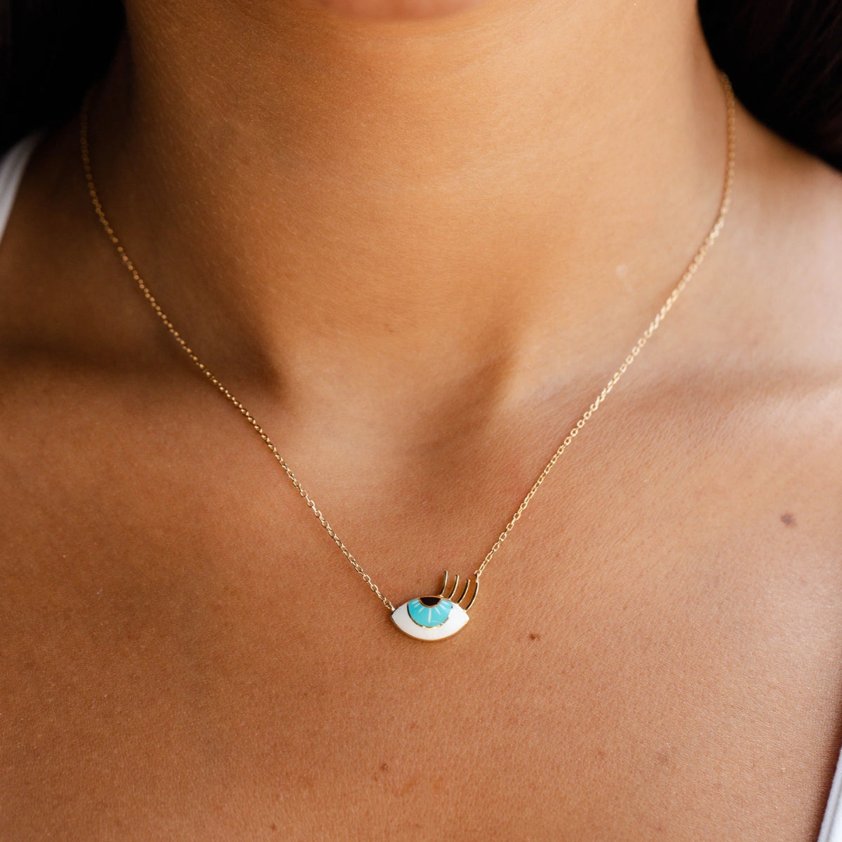 Model wearing Orchid Jewelry 18k yellow gold small flirty aqua eye enamel pendant necklace