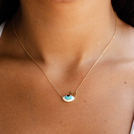 Model wearing Orchid Jewelry 18k yellow gold small flirty aqua eye enamel pendant necklace