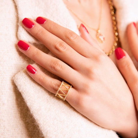 Model wearing Orchid Jewelry 18k yellow gold and diamond Soho Buz wide openwork statement ring on finger