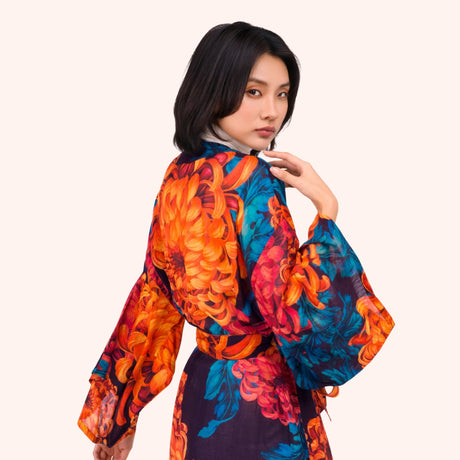 Back view of the chrysanthemum print kimono gown, showing the wide sleeve drape and full print scale