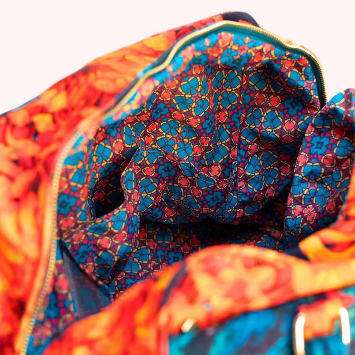 Close-up of the weekend bag's open interior, showing the vibrant kaleidoscope print lining