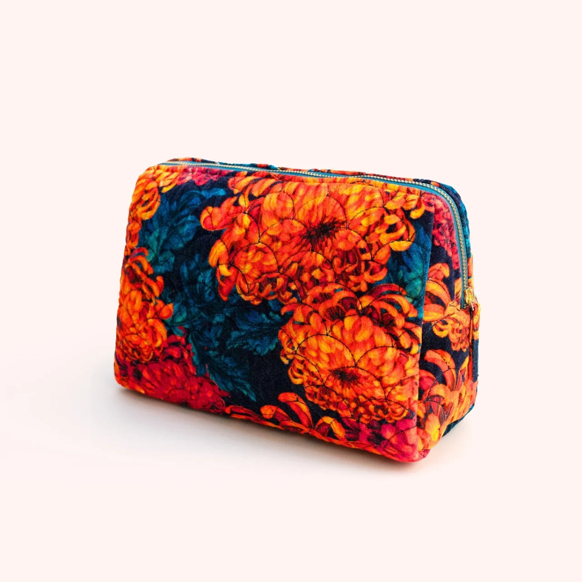 Orange and teal chrysanthemum print quilted velvet washbag, shown at an angle with zip closure