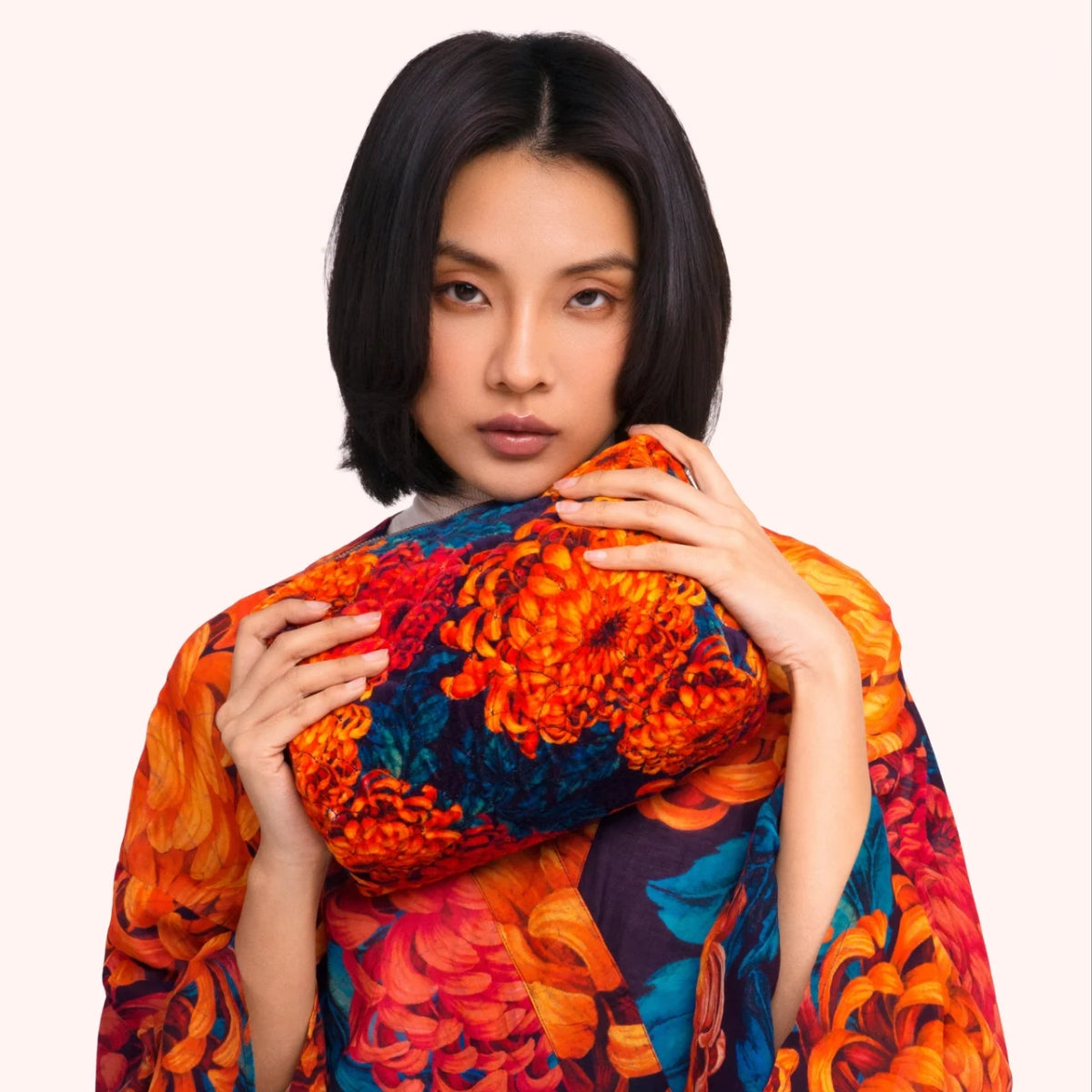 Model holding the chrysanthemum print quilted velvet washbag against the matching kimono print