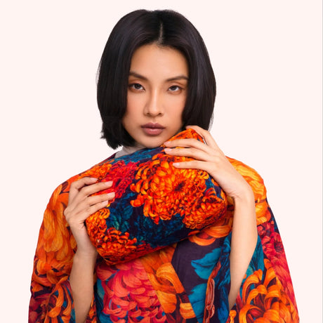 Model holding the chrysanthemum print quilted velvet washbag against the matching kimono print