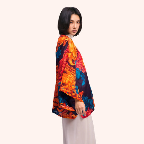 Side profile of the chrysanthemum print kimono jacket, showing the wide sleeve drape and open front silhouette