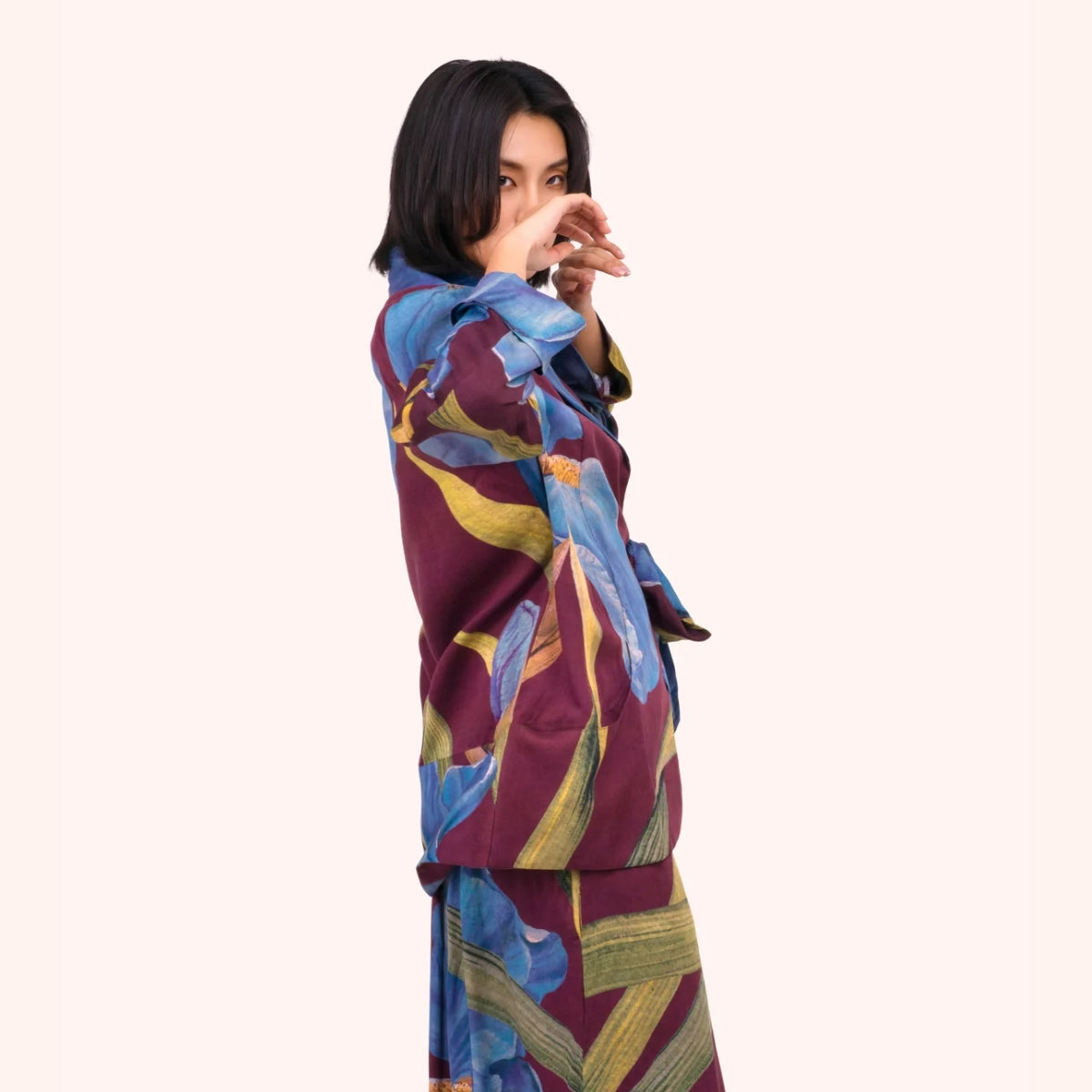 Side profile of the plum iris print jacket, showing the relaxed wrap silhouette and sleeve detail