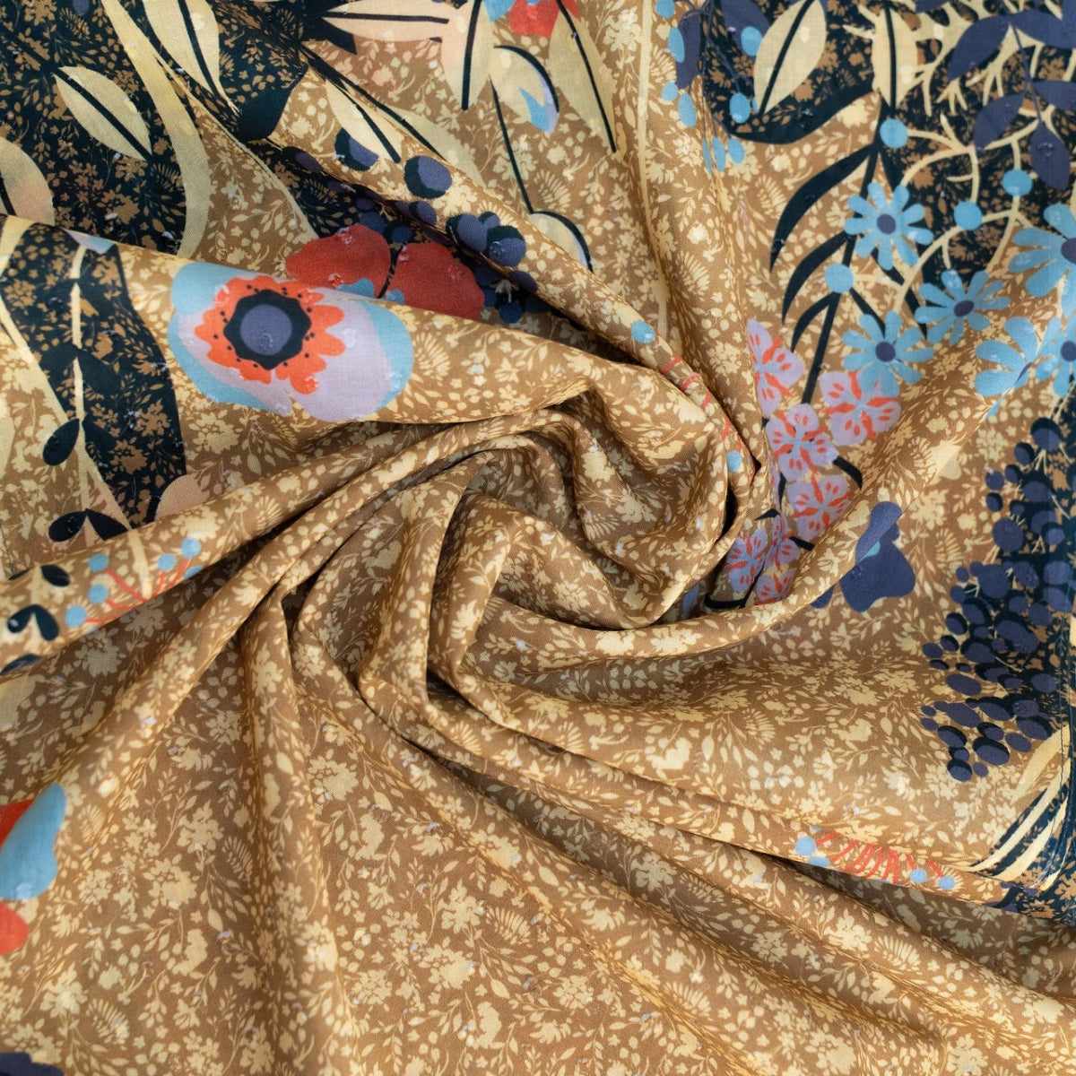 Close-up of the moss floral hedgerow scarf fabric, showing the crisp cotton poplin texture and layered floral print