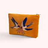 Mustard velvet zip pouch hand embroidered and beaded with two swallows in flight carrying pink blossoms