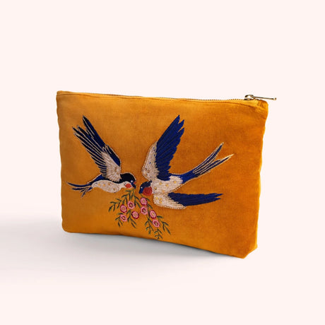 Mustard velvet zip pouch hand embroidered and beaded with two swallows in flight carrying pink blossoms
