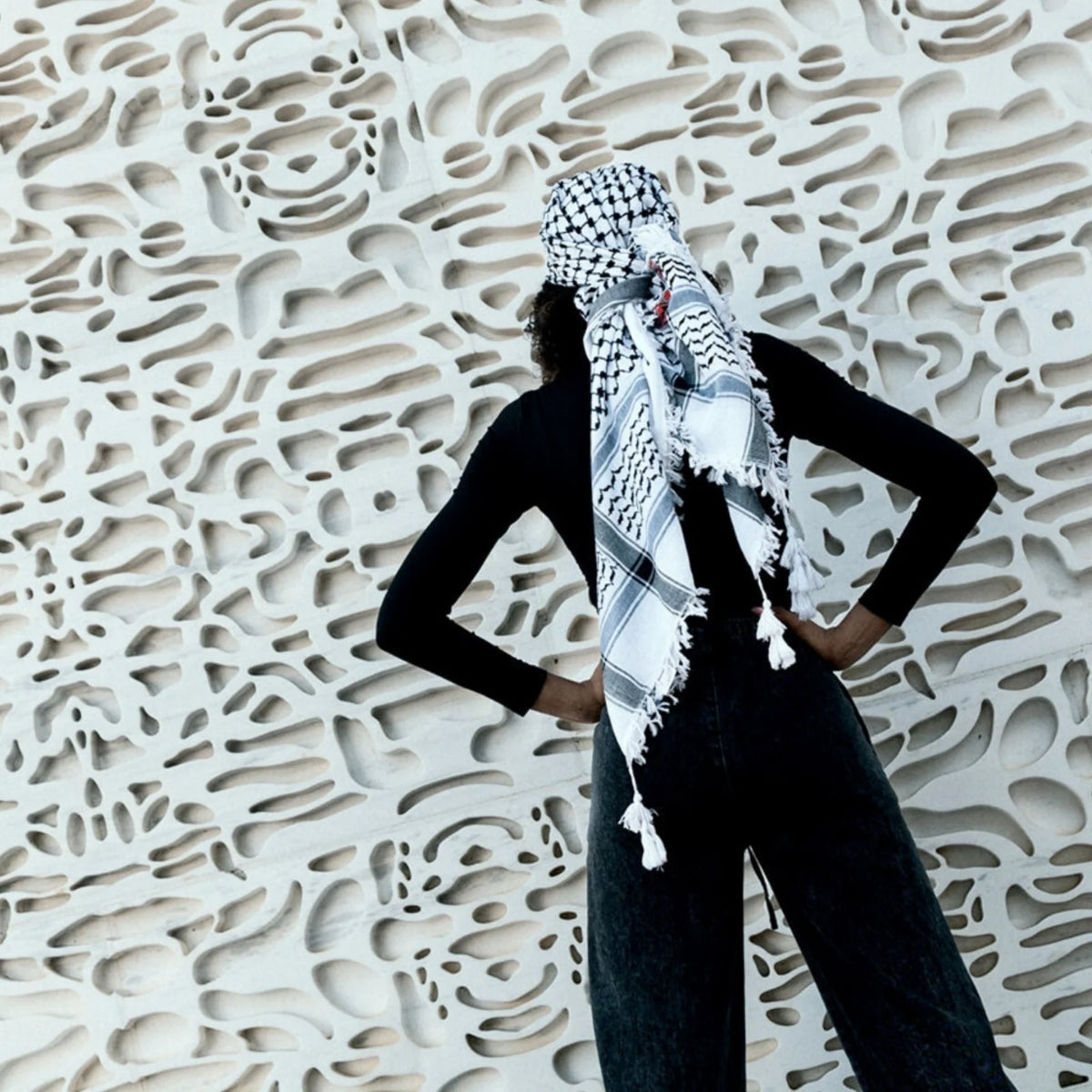 SEP folded black and white cotton keffiyeh scarf featuring hand-embroidered red Makateeb geometric border stitching and white tassels