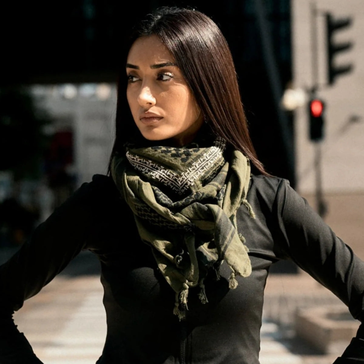 Model wearing SEP khaki green cotton keffiyeh scarf wrapped comfortably around the neck outdoors