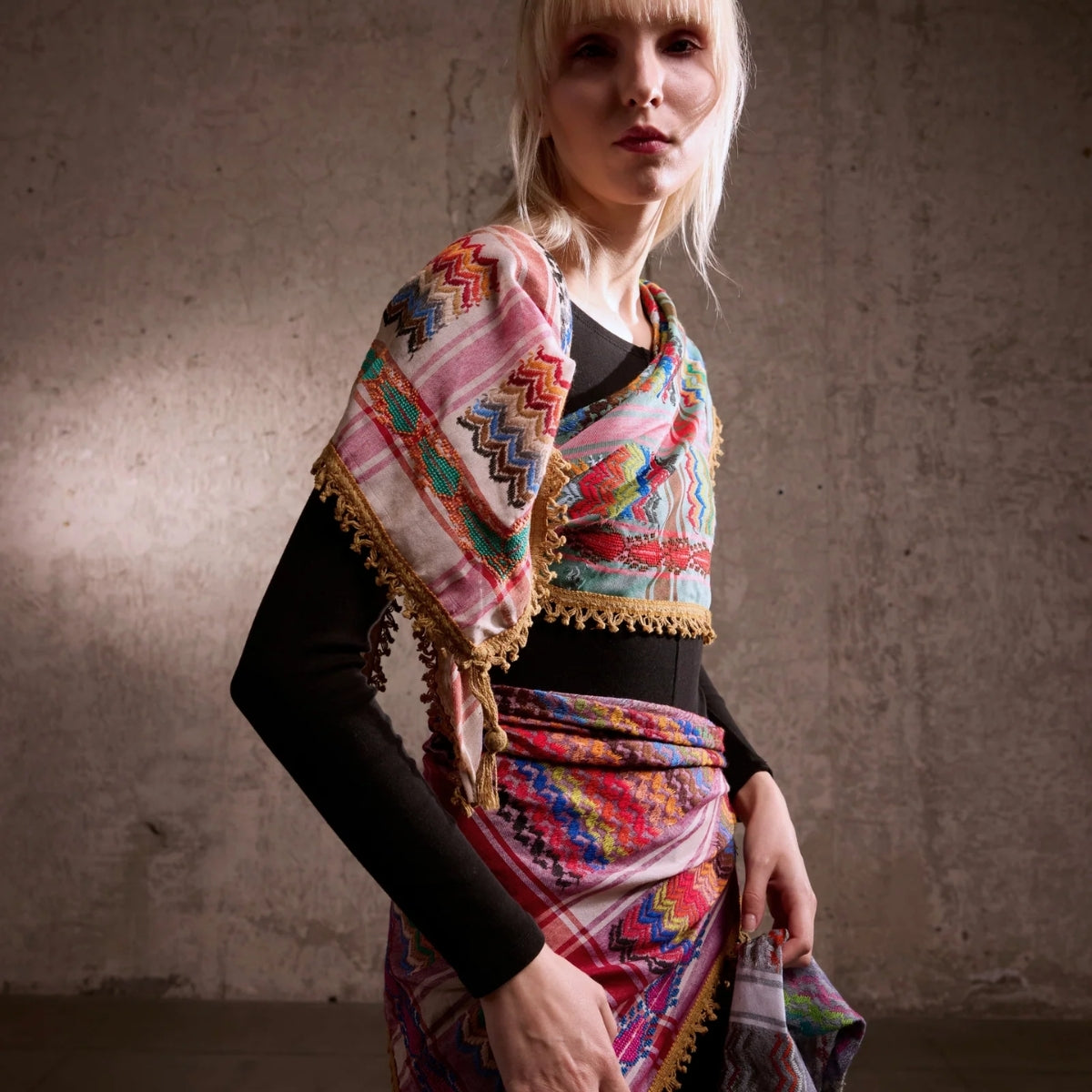 Model wearing SEP mini green multicolor keffiyeh scarf draped over the shoulder as an artistic fashion accessory
